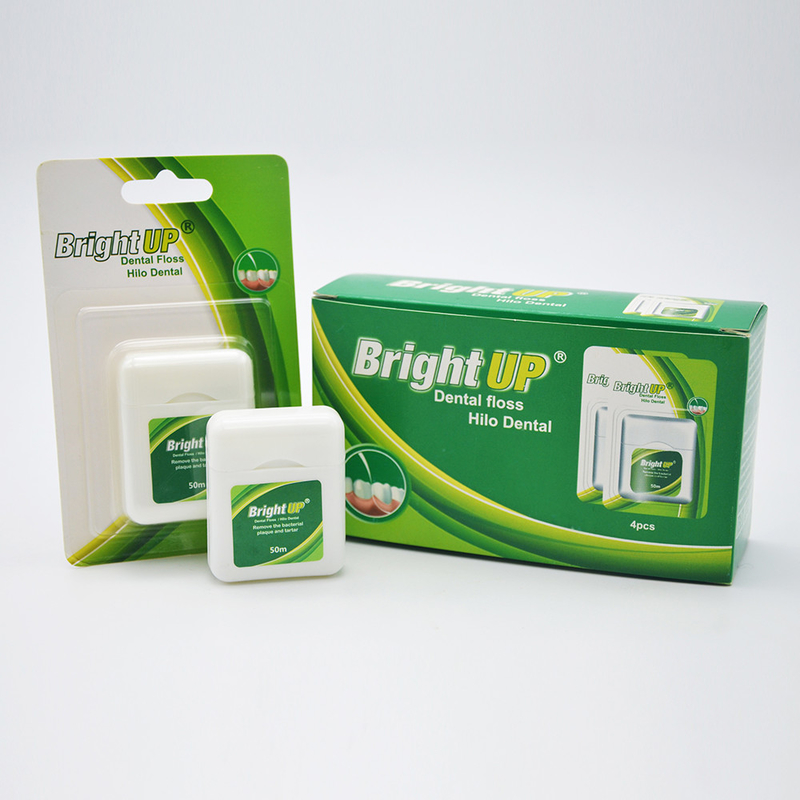 La boîte de fil dentaire ou le fil dentaire biodégradable de fines herbes sélectionnent le soin oral vous gardent sourire